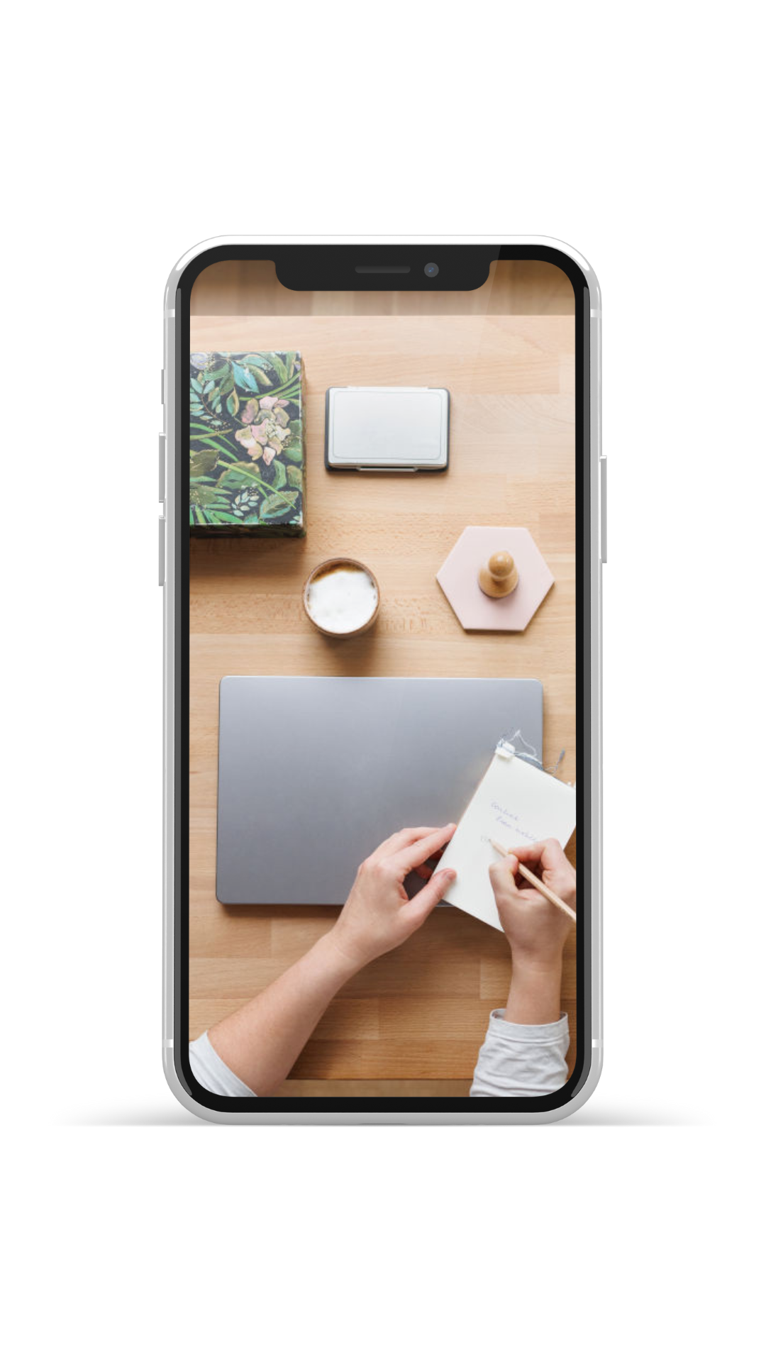 Schreibtisch mit Laptop, Notizblock und Wasserglas